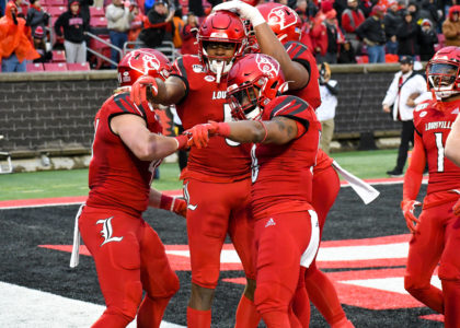 Louisville football players celebrate in the endzone