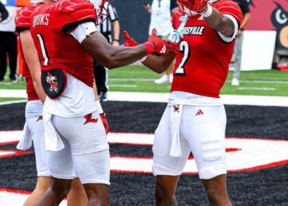 Louisville Football player Jadon Thompson (2) celebrates after a touchdown with Ja'Corey Brooks (1) and Tyler Shough (9).