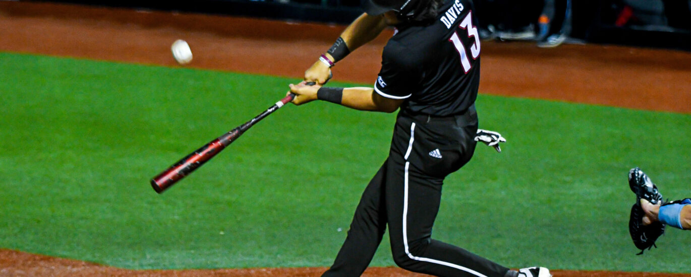 Tague Davis swings at a pitch in a Louisville Baseball Game Photo by Jared Anderson