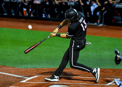 Tague Davis swings at a pitch in a Louisville Baseball Game Photo by Jared Anderson