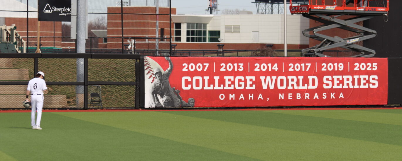 Left Fielder Griffin Crain and the College World Series Banner in Left Center Field at Jim Patterson Stadium Photo by Ryan Hammel